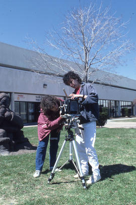 Photograph of students setting up a camera outside