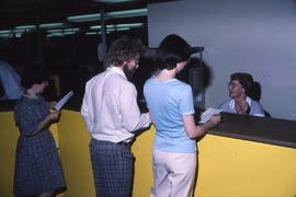 Photograph of staff posing as students in the Registration Centre