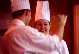 Photograph of two Culinary program students laughing together