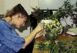 A photograph of a Retail Floriculture student working on their arrangement