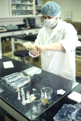 Photograph of a Pharmacy Assistant Student Preparing a Syringe