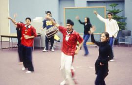 Photograph of students performing a dance in the Lecture Theatre.