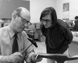 Photograph of Harold Stacey Assisting a Student with an Anvil