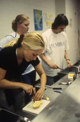 A photograph of students in the Bartending lab