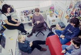 Photograph of students seated in a residence dorm