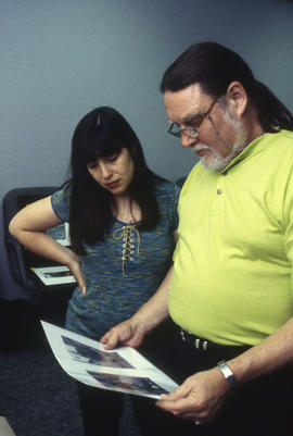 Photograph of Faculty members reviewing students work