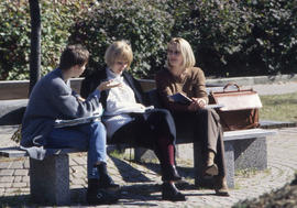 Photograph of three friends seated on a bench