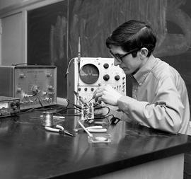 Photograph of Alan Ferguson working with electronics