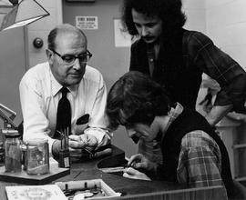 Photograph of Harold Stacey Watching his Student working with Jewellery in the Lab