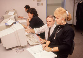 Photograph of instructor Jim Hardy helping a student in class