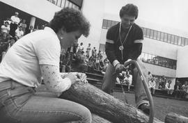 Photograph of Students Participating in a Log Cutting Contest at Student Orientation