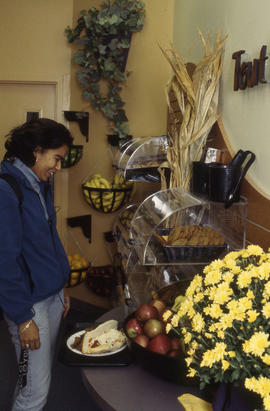 Photograph of a student examining the food choices in the cafeteria
