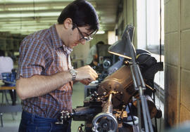 Photograph of a student operating a metal lathe