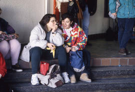 Photograph of Two People Watching an Elvis Impersonator