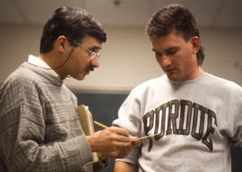 Photograph of a faculty member with a student in Electronics class