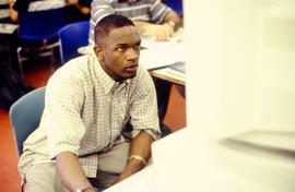 A photograph of a student working on a computer