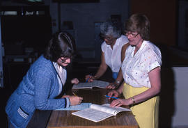 Photograph of staff members testing the computer system