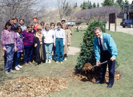 Photograph of Stephen Bodsworth with shovel in hand while others look on