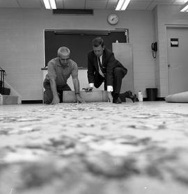 Photograph of a Carpet laying instructor giving directions