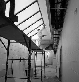 Photograph of a plasterer working inside the D-building