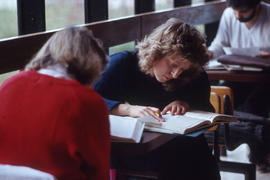Photograph of two students working on assignments