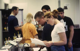 A photograph of students in the Bartending lab