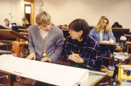 Photograph of faculty member Susan Topping working with a student
