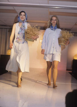 Photograph of Two Women Walking Down the Runway