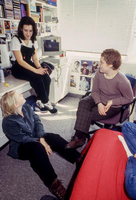 Photograph of students sitting and chatting in the residence dorm
