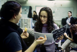 Photograph of two students in discussion in the journalism lab