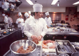 Photograph of culinary working with stuffed pork