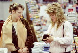 Photograph of students looking at a floppy disk in the Bookstore