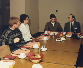 Photograph of students and faculty in a meeting