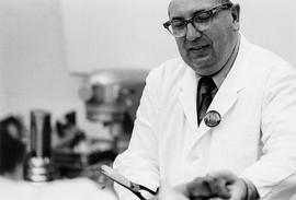 Photograph of Igor Sukor Working in the KItchen with Scissors