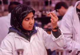 Photograph of student examining a test tube in the Chemistry lab