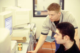 Photograph of two students working at a computer in the H205 open lab