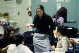 Photograph of a group of students in discussion in the Journalism lab