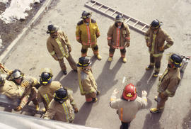 A photograph of a Firefighting instructor speaking to students