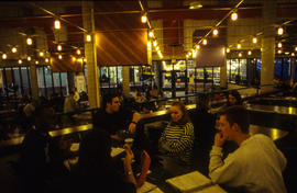 Photograph of Tracy Boyer sitting with friends in the Pipe cafeteria