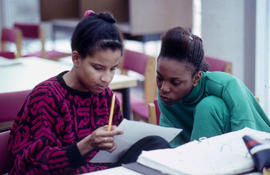 Photograph of two students working in a resource area