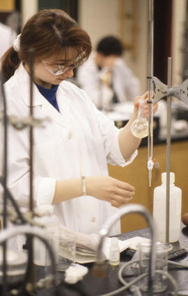 Photograph of a Chemistry Student Using a Beaker in the Lab