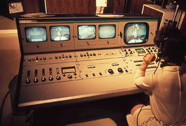 Photograph of Someone Using a Video Control Console at the IMC