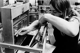 Photograph of a Student Loading Yarn into a Loom