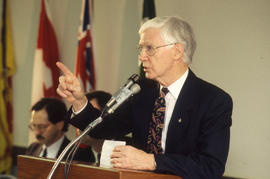 Photograph of a Daimler-Chrysler executive speaking to employees of their training program