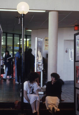 Photograph of students talking on the steps of the concourse