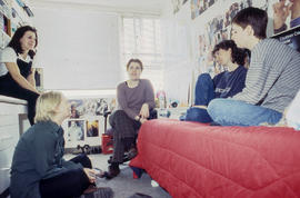 Photograph of students gathered together and chatting in a residence dorm