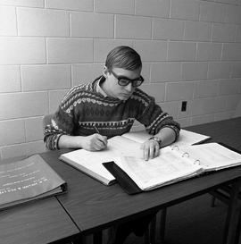 Photograph of Yves Hamel studying
