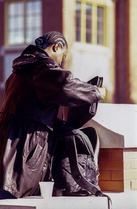 Photograph of a student packing her backpack