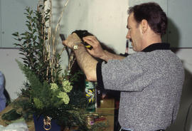 A photograph of a Retail Floriculture student fixing their arrangement