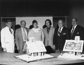 Photograph of Gordon Wragg and Igor Sukor Displaying the Gingerbread Houses to the Hospital Execu...